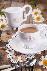 Coffee with milk,Breakfast in the morning with a book and flowers.selective focus