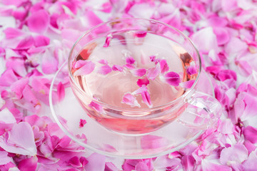 Tea with rose petals in a glass Cup. Rose water.