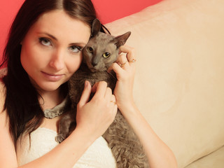 Obraz premium woman on sofa playing with cat