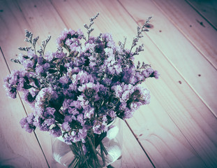 statice flower bouquet  on wood background - soft focus with vin