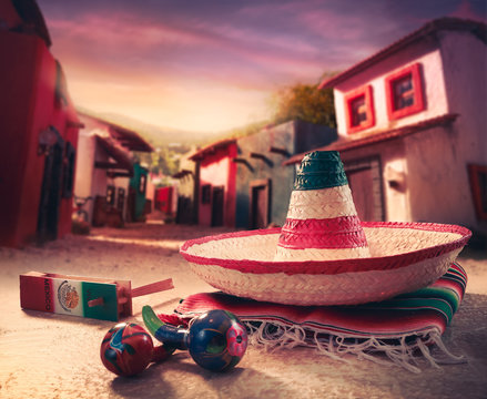 Mexican hat, or "sombrero" and rattles on a "serape"
