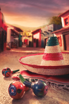Mexican hat, or "sombrero" and rattles on a "serape"