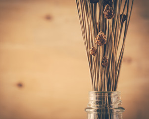dry grass flower on wood background