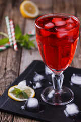 Red Cocktail with mint and ice, selective focus