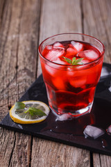 Red Cocktail with mint and ice, selective focus