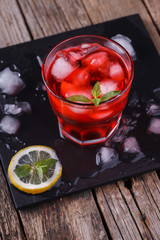 Red Cocktail with mint and ice, selective focus