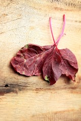 red spinach on a wooden vintage