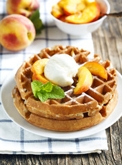 Belgian waffles with ice cream and fresh peaches