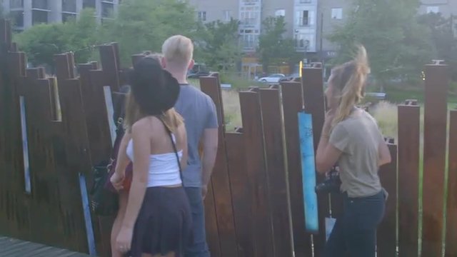 Attractive teens walking on park path look around at the city