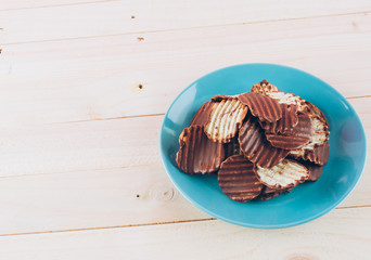 potato chip with chocolate on wood
