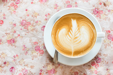 Cup of art latte or cappuccino coffee with retro filter effect a