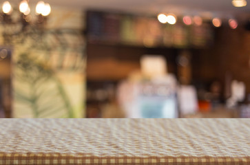 checkered table cloth on empty table and restaurant or cafe for