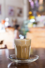 hot latte coffee on wooden table, vintage and retro style