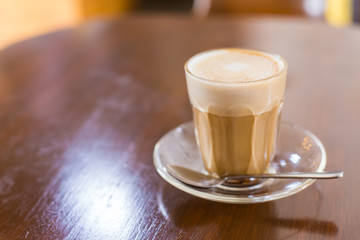 hot latte coffee on wooden table, vintage and retro style