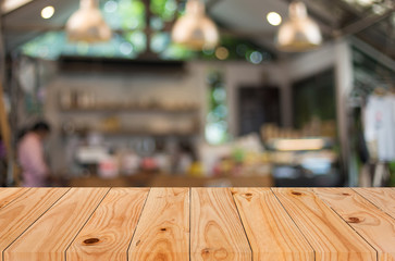 Selected focus empty brown wooden table and Coffee shop blur bac