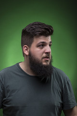 Portrait male, looking to the right. Green screen background.