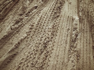 Wheel tracks on the soil.