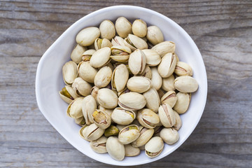 close up of pistachio nuts on wood table background