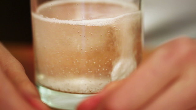 Dissolving effervescent tablet in water glass
