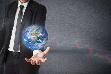 Businessman holds Earth in a hand with stock graph. Concept of r