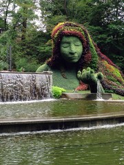Amazing garden landscape design with a green sculpture of a mother nature