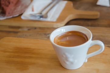 Cup of coffee on wooden table