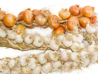 Bundle of onions and on garlic a light background closeup
