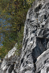 Marble rock, covered with trees. Mountain Park Ruskeala (Karelia, Russia)