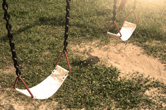 Playground swing lonely in the park and garden.