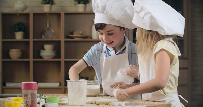 Little siblings learning to bake together 