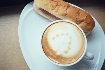 Vintage latte coffee with fast food hot dog