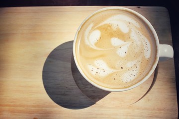 Vintage latte art coffee with shadow