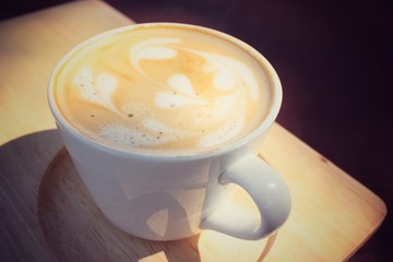 Vintage latte art coffee with shadow