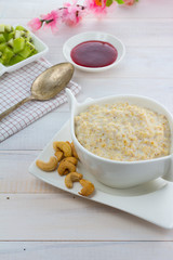 Porridge with kiwi and banana over wooden vintage background