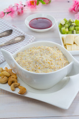 Porridge with kiwi and banana over wooden vintage background