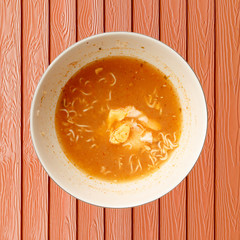 Dirty noodle in dish on wooden table