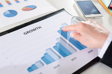 Businesswoman pointing her finger on a graph