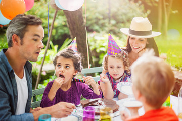Family sharing the birthday cake.