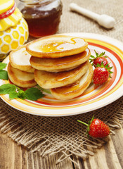 Homemade pancake with honey and strawberry