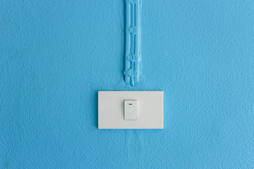 Electrical   light switch on blue wall.