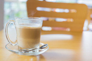 hot latte coffee on wooden table, vintage and retro style