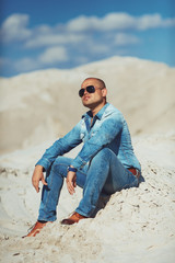 Obraz premium Full length portrait of happy man on a background of sand