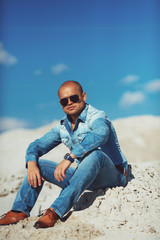 Obraz premium Young Attractive Man Relaxing at the Beach