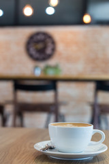 Hot art Latte Coffee in a cup on wooden table