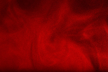 Red powder cloud against dark background