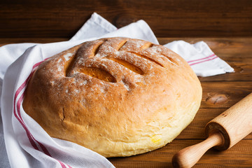 Freshly baked homemade bread on wooden background