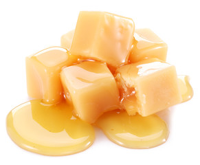 Sweet caramel candies on the white background.