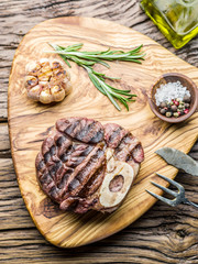 Beef steaks  with spices on a wooden tray.