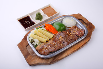 Beef Sirloin steak on hot plate with triple sauce isolated on white background.