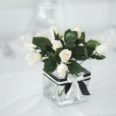 Wedding table with white roses.